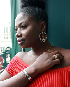 Woman wearing sterling silver tribal krobo bead earrings