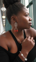 Load image into Gallery viewer, Woman wearing sterling silver krobo bead stud dangle earrings and a krobo bead bracelet 