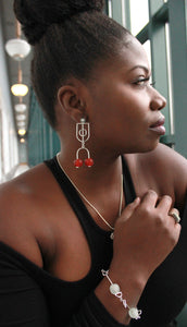 Woman wearing sterling silver krobo bead stud dangle earrings and a krobo bead bracelet 