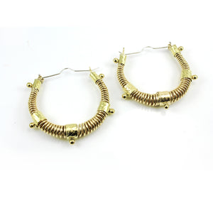 Large gold toned West African inspired statement hoop earrings