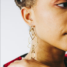 Load image into Gallery viewer, Woman wearing gold tone cascading geometric shaped earrings